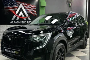 Black SUV with AlfaShieldPPF branding parked in a premium car detailing studio showcasing glossy finish and paint protection film installation